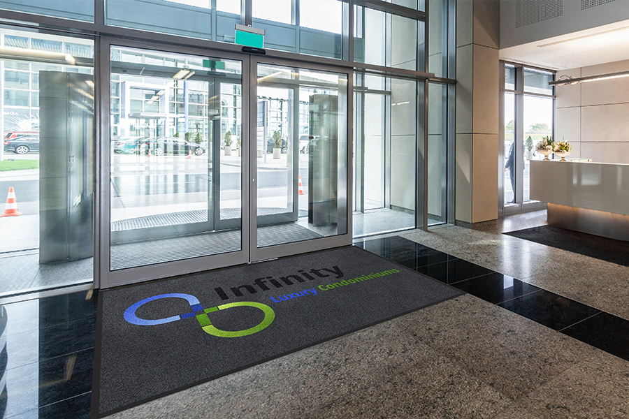 Custom logo mat at building entrance — Infinity Luxury Condominiums