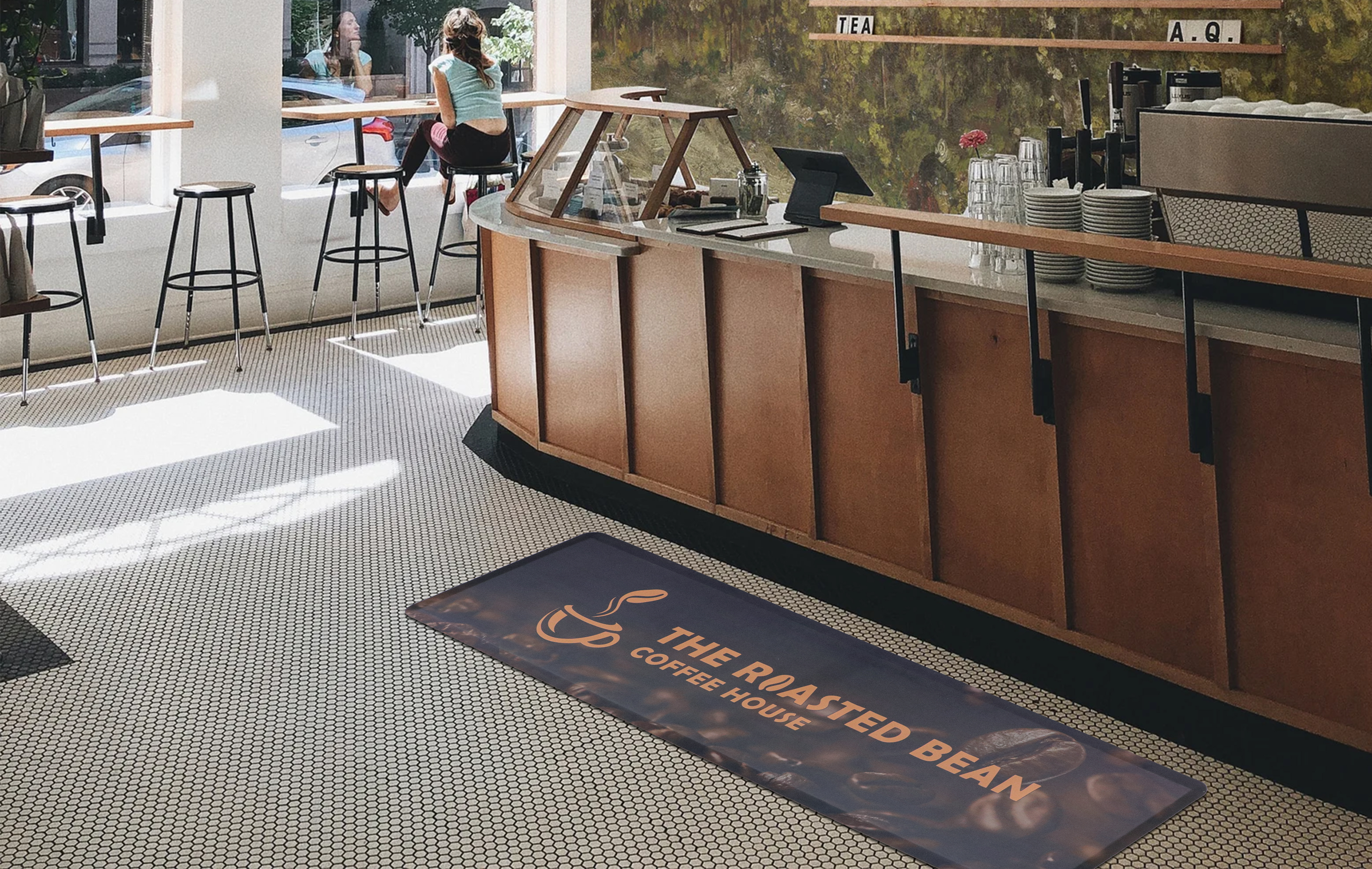 Custom logo mat at coffee shop counter — The Roasted Bean